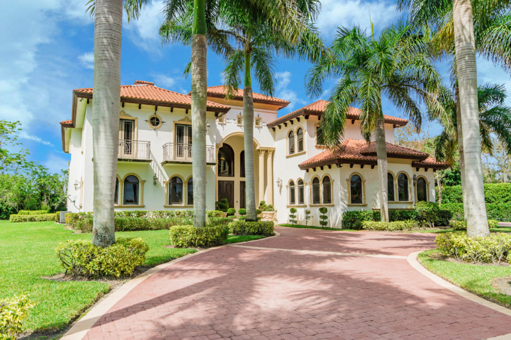 Mediterranean-style luxury estate in Wellington, Florida with tile roof and arched windows
