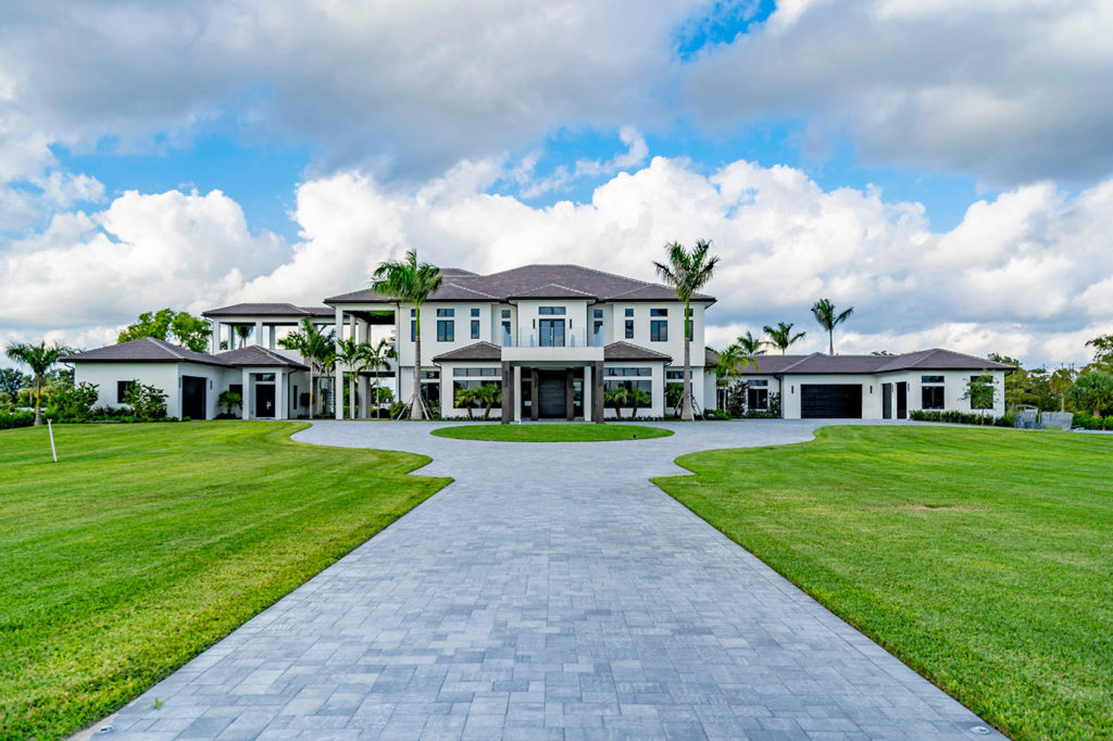 Wellington luxury estate home with circular drive and mature palms